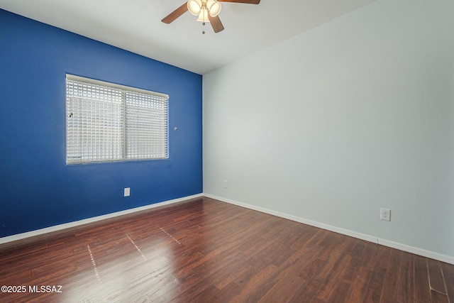 spare room with ceiling fan, wood finished floors, and baseboards