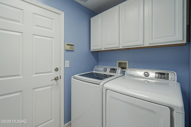 laundry area featuring washing machine and dryer and cabinet space