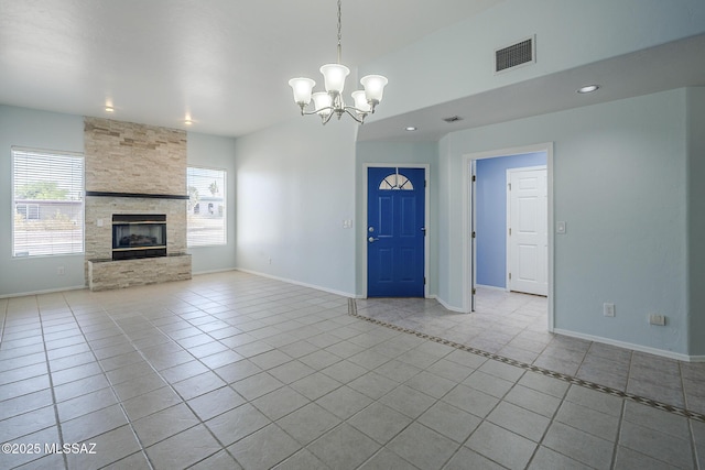 unfurnished living room featuring tile patterned floors, a chandelier, baseboards, recessed lighting, and a stone fireplace