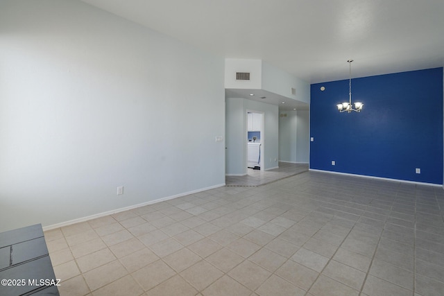 unfurnished room with a chandelier, baseboards, and tile patterned floors