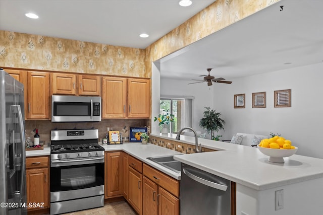 472 W Calle Sedillo, Sahuarita, AZ 85629 - kitchen with stainless steel appliances, a sink, a peninsula, light countertops, and recessed lighting