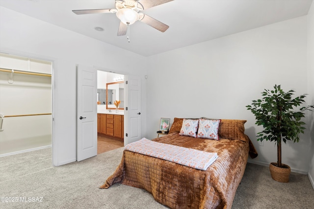 472 W Calle Sedillo, Sahuarita, AZ 85629 - bedroom featuring light carpet, baseboards, a spacious closet, ceiling fan, and ensuite bath