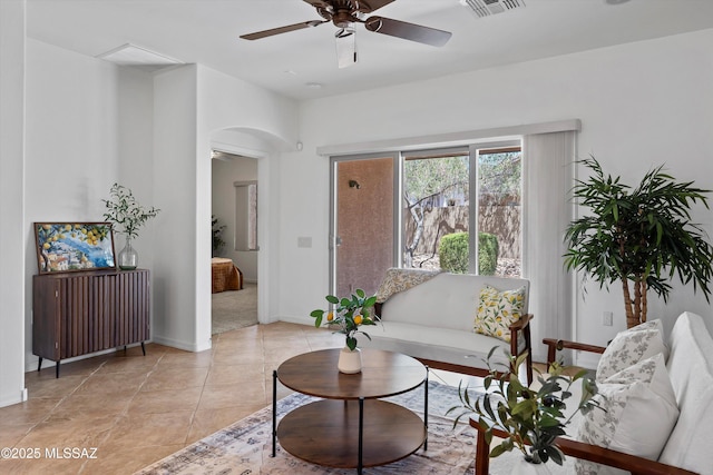 472 W Calle Sedillo, Sahuarita, AZ 85629 - living room featuring arched walkways, a ceiling fan, baseboards, and light tile patterned floors