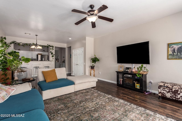 21185 E Reunion Rd, Red Rock, AZ 85145 - living area featuring wood finished floors, a ceiling fan, baseboards, and a chandelier