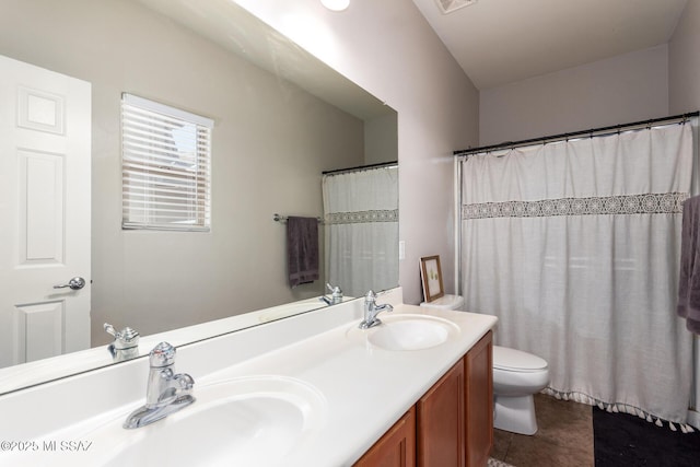 21185 E Reunion Rd, Red Rock, AZ 85145 - full bathroom featuring toilet, double vanity, and tile patterned flooring