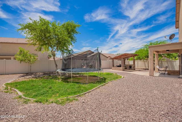 21185 E Reunion Rd, Red Rock, AZ 85145 - fenced backyard with a trampoline and a patio