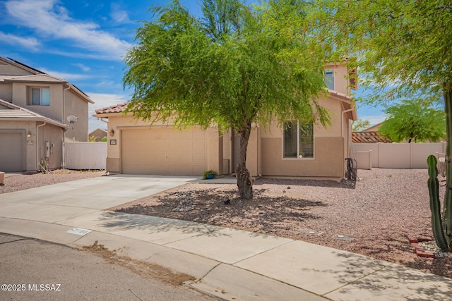21185 E Reunion Rd, Red Rock, AZ 85145 - view of front facade featuring stucco siding, concrete driveway, an attached garage, fence, and a tile roof