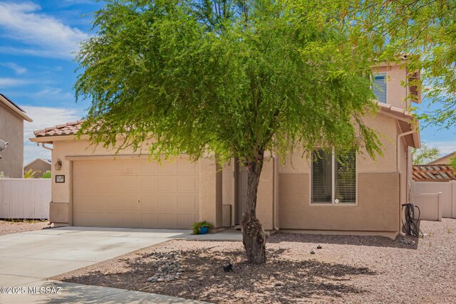 21185 E Reunion Rd, Red Rock, AZ 85145 - view of front of home with an attached garage, stucco siding, and fence