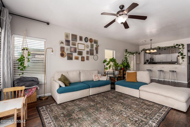 21185 E Reunion Rd, Red Rock, AZ 85145 - living area featuring ceiling fan, wood finished floors, baseboards, and a chandelier
