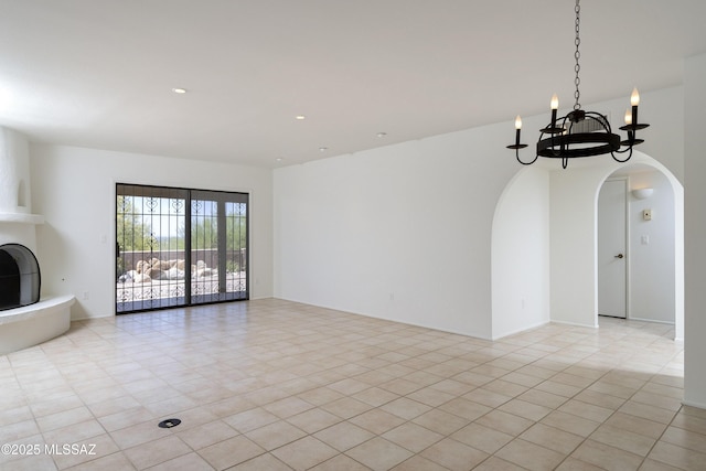 5790 E Chiricahua Trl, Tucson, AZ 85750 - unfurnished living room featuring arched walkways, a chandelier, recessed lighting, and light tile patterned flooring