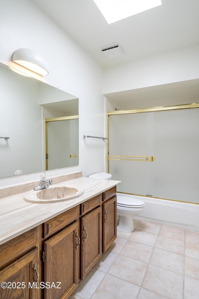 5790 E Chiricahua Trl, Tucson, AZ 85750 - full bathroom with vanity, tile patterned flooring, toilet, and shower / bath combination with glass door