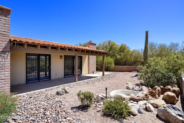 5790 E Chiricahua Trl, Tucson, AZ 85750 - rear view of house with a patio, a chimney, and a tile roof
