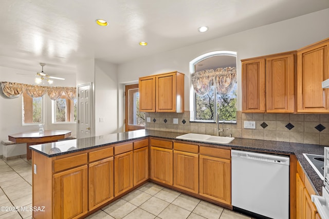 12220 E 5th St, Tucson, AZ 85748 - kitchen featuring white dishwasher, a peninsula, light tile patterned floors, a sink, and recessed lighting
