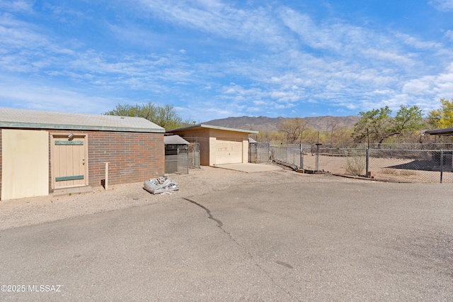 12220 E 5th St, Tucson, AZ 85748 - view of yard featuring fence, dirt driveway, a mountain view, and an outbuilding