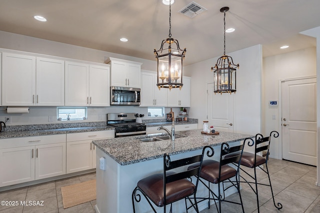 11267 S Weismann Dr, Vail, AZ 85641 - kitchen with appliances with stainless steel finishes, a sink, light tile patterned flooring, dark stone counters, and recessed lighting