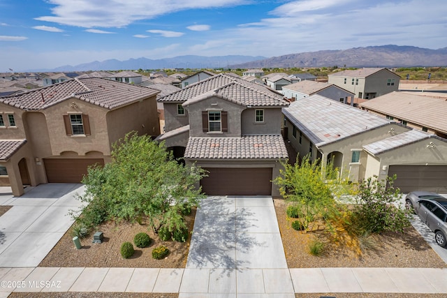 11267 S Weismann Dr, Vail, AZ 85641 - mediterranean / spanish house featuring a residential view, concrete driveway, and a garage
