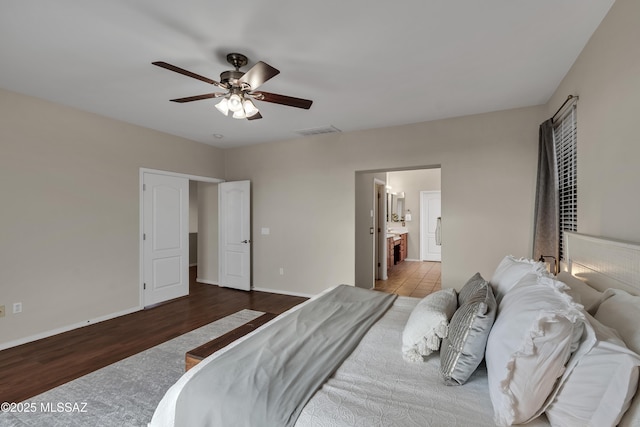 10676 S Miramar Canyon Pass, Vail, AZ 85641 - bedroom featuring wood finished floors, baseboards, ensuite bathroom, and ceiling fan