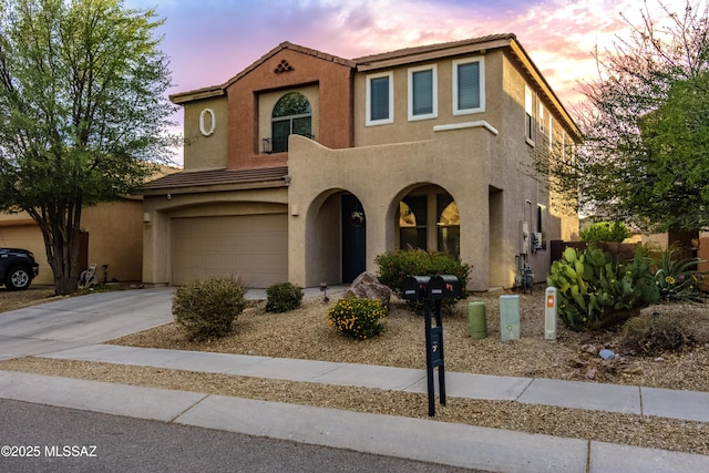 10676 S Miramar Canyon Pass, Vail, AZ 85641 - mediterranean / spanish-style house with a garage, stucco siding, concrete driveway, and a tiled roof