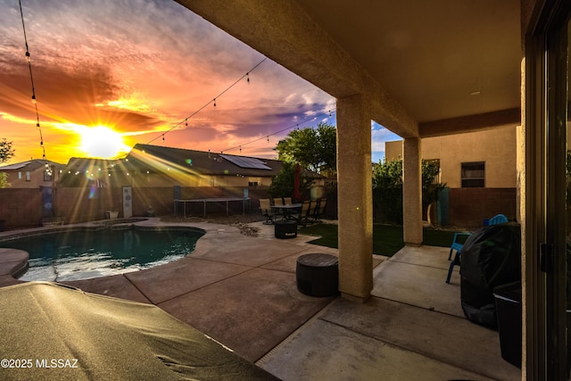 10676 S Miramar Canyon Pass, Vail, AZ 85641 - pool at dusk with a fenced backyard, a patio, grilling area, and a pool with connected hot tub