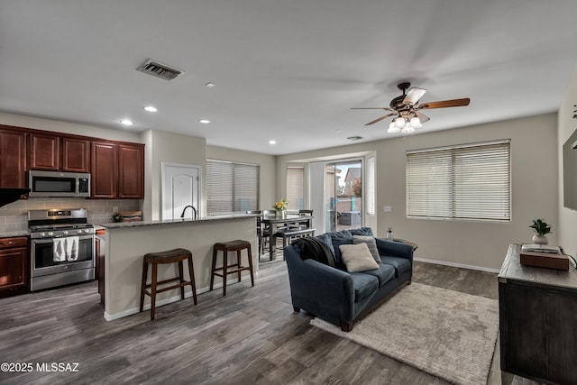 10676 S Miramar Canyon Pass, Vail, AZ 85641 - living room featuring dark wood-type flooring, a ceiling fan, recessed lighting, and baseboards