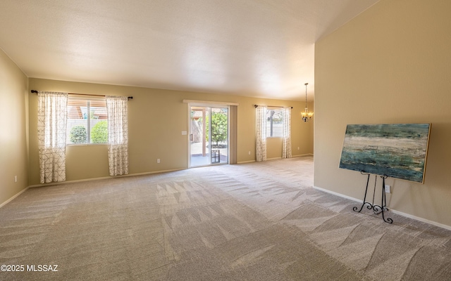 9664 E Paseo, San Rosendo, Tucson, AZ 85747 - unfurnished living room with carpet flooring, a chandelier, and baseboards
