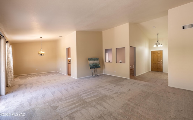 9664 E Paseo, San Rosendo, Tucson, AZ 85747 - unfurnished living room featuring a chandelier, carpet, baseboards, and high vaulted ceiling
