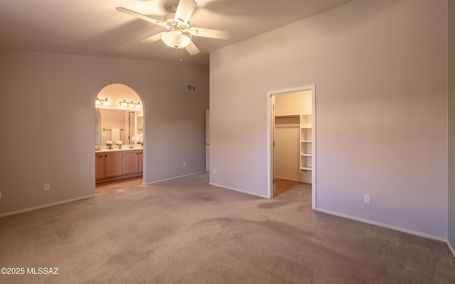 9664 E Paseo, San Rosendo, Tucson, AZ 85747 - unfurnished bedroom with light colored carpet, a spacious closet, and baseboards