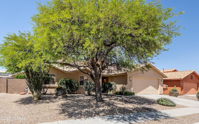 9664 E Paseo, San Rosendo, Tucson, AZ 85747 - view of front of home featuring a garage, stucco siding, and concrete driveway
