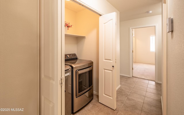 9664 E Paseo, San Rosendo, Tucson, AZ 85747 - washroom featuring washing machine and clothes dryer, light tile patterned floors, and baseboards