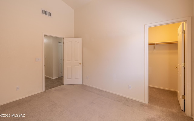 9664 E Paseo, San Rosendo, Tucson, AZ 85747 - unfurnished bedroom featuring carpet flooring, a spacious closet, high vaulted ceiling, baseboards, and a closet
