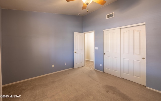 9664 E Paseo, San Rosendo, Tucson, AZ 85747 - unfurnished bedroom featuring carpet flooring, a closet, baseboards, a ceiling fan, and a high ceiling
