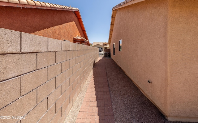 9664 E Paseo, San Rosendo, Tucson, AZ 85747 - view of side of home featuring stucco siding and central AC