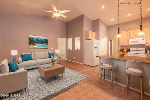 9664 E Paseo, San Rosendo, Tucson, AZ 85747 - living room featuring high vaulted ceiling, ceiling fan, light tile patterned floors, and baseboards