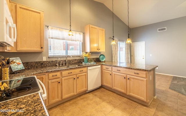 9664 E Paseo, San Rosendo, Tucson, AZ 85747 - kitchen with white appliances, high vaulted ceiling, light brown cabinets, a peninsula, and plenty of natural light