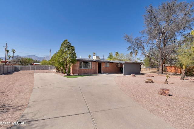 8105 E Beverly St, Tucson, AZ 85710 - ranch-style house featuring concrete driveway, brick siding, and a gate