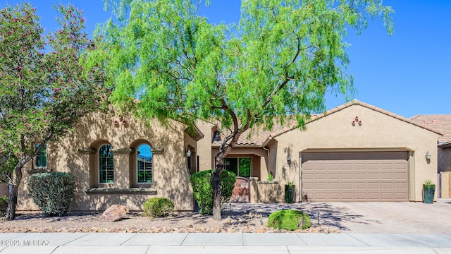 4762 W Placita Casa Sevilla, Marana, AZ 85658 - mediterranean / spanish house featuring a garage, driveway, stucco siding, and a tile roof