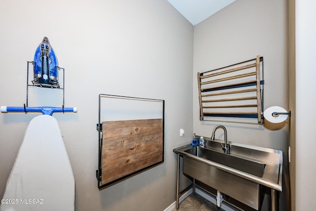 4762 W Placita Casa Sevilla, Marana, AZ 85658 - bathroom with radiator heating unit, lofted ceiling, a sink, and baseboards