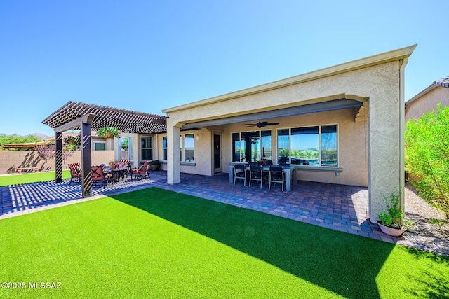 4762 W Placita Casa Sevilla, Marana, AZ 85658 - rear view of property featuring stucco siding, fence, a ceiling fan, a patio area, and a pergola