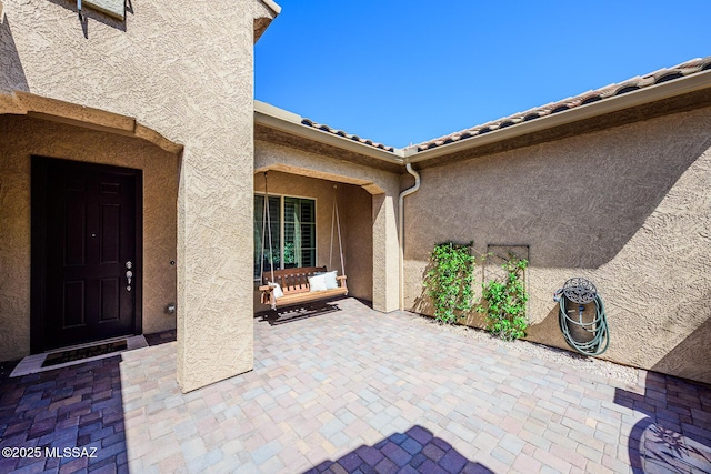 4762 W Placita Casa Sevilla, Marana, AZ 85658 - property entrance with stucco siding, a patio, and a tile roof