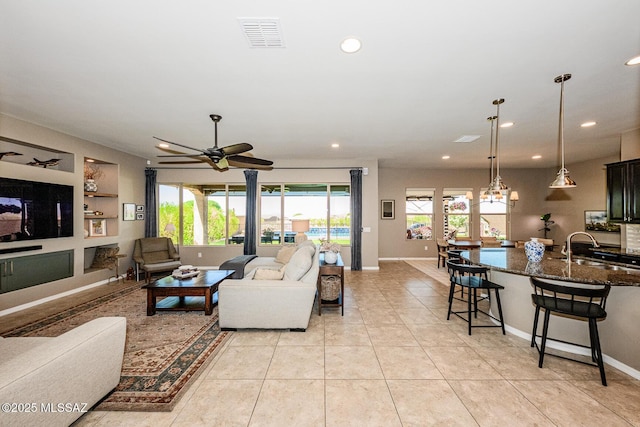 4762 W Placita Casa Sevilla, Marana, AZ 85658 - living area featuring a ceiling fan, recessed lighting, baseboards, and light tile patterned floors
