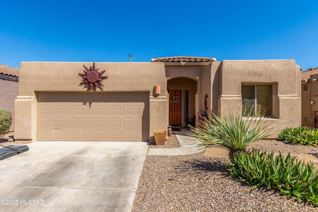 8434 N Sunny Rock Ridge Dr, Tucson, AZ 85743 - pueblo-style house with stucco siding, a garage, a tile roof, and driveway
