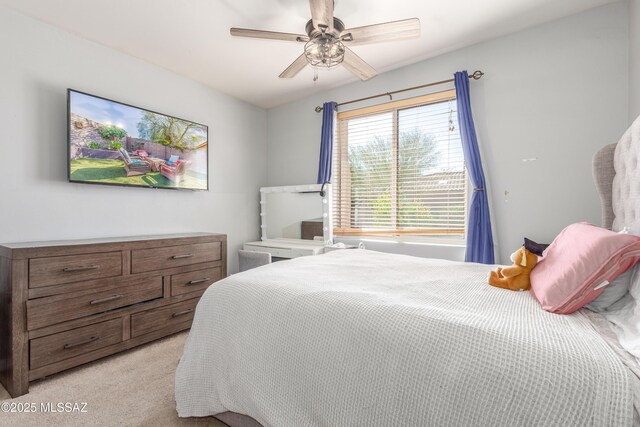 8434 N Sunny Rock Ridge Dr, Tucson, AZ 85743 - bedroom with light colored carpet and a ceiling fan