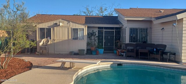 4081 N Hidden Cove Pl, Tucson, AZ 85749 - back of house featuring an outdoor pool, a patio area, and roof with shingles