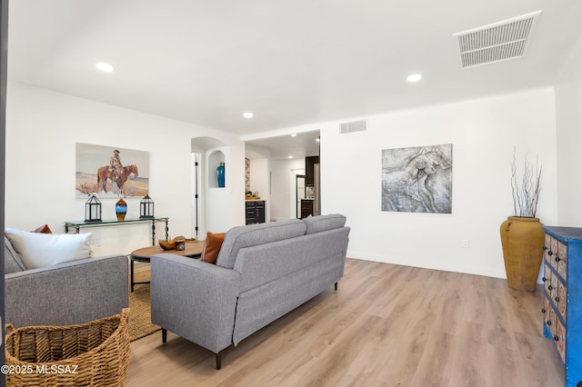 2610 E Elm St, Tucson, AZ 85716 - living area with arched walkways, light wood-type flooring, and recessed lighting