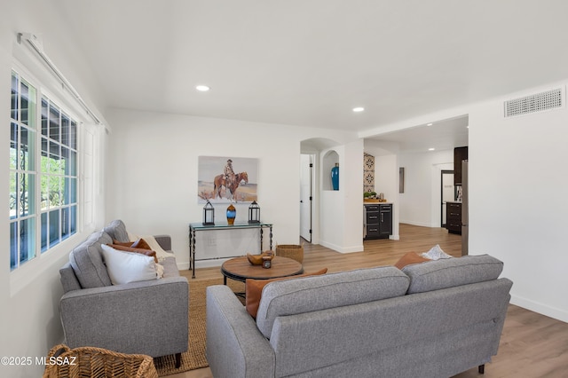 2610 E Elm St, Tucson, AZ 85716 - living area with arched walkways, light wood-type flooring, recessed lighting, and baseboards