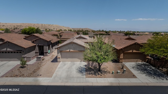 1104 W Pastora Peak Dr, Green Valley, AZ 85614 - single story home with concrete driveway, a residential view, and stucco siding