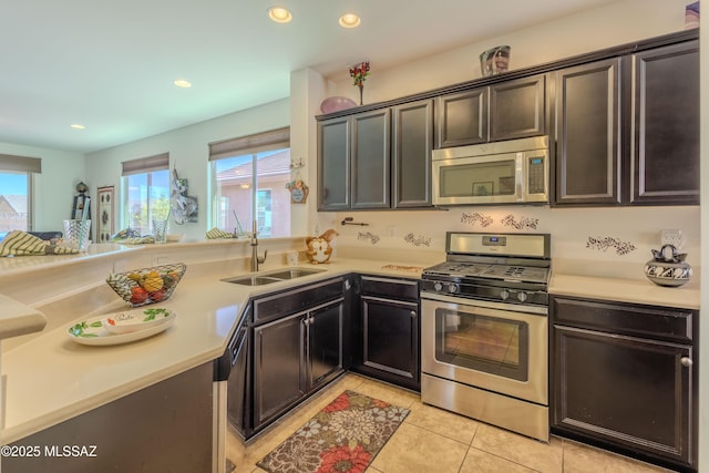 1104 W Pastora Peak Dr, Green Valley, AZ 85614 - kitchen with stainless steel appliances, a sink, light countertops, light tile patterned floors, and recessed lighting