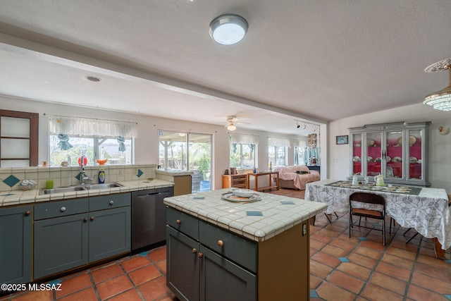 2621 W Rapallo Way, Tucson, AZ 85741 - kitchen featuring dishwasher, a sink, tile countertops, backsplash, and a textured ceiling