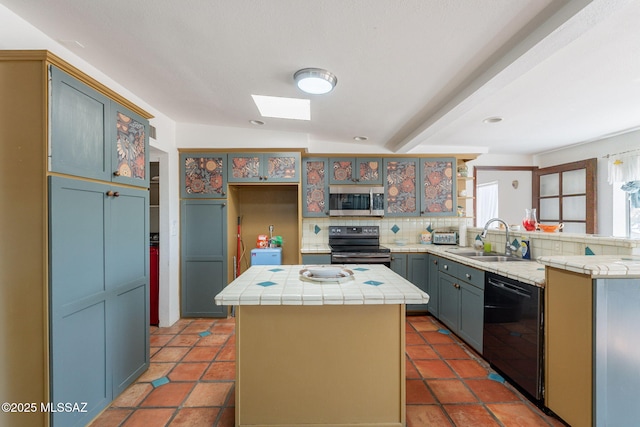 2621 W Rapallo Way, Tucson, AZ 85741 - kitchen featuring stainless steel appliances, a sink, tile counters, decorative backsplash, and a skylight