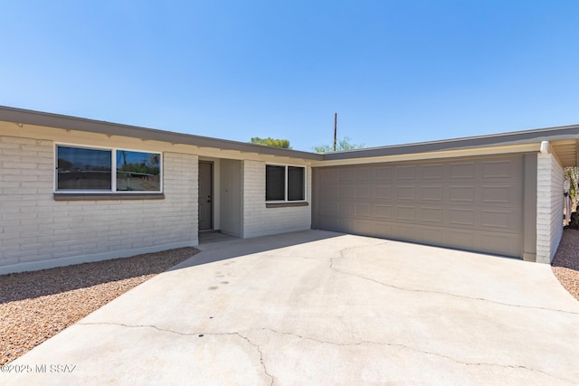 2302 S Cathy Ave, Tucson, AZ 85710 - single story home featuring driveway, a garage, and brick siding
